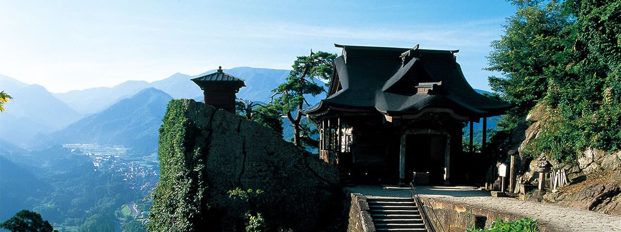 Steep steps on mountain path to the green alpine valley