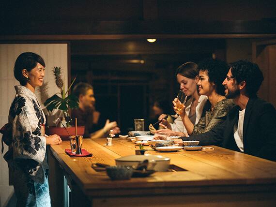 Tourists enjoying sake in an old house